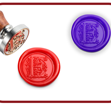 Red and purple monogram wax seals next to a brass wax stamp with a wooden handle