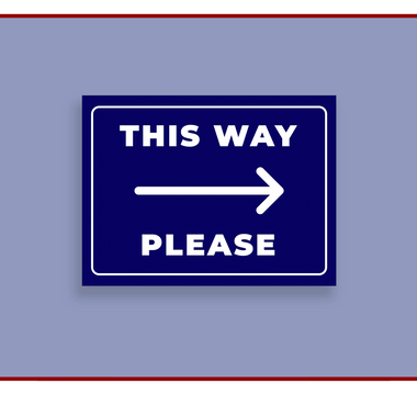Wayfinding sign reading This Way Please with a directional arrow