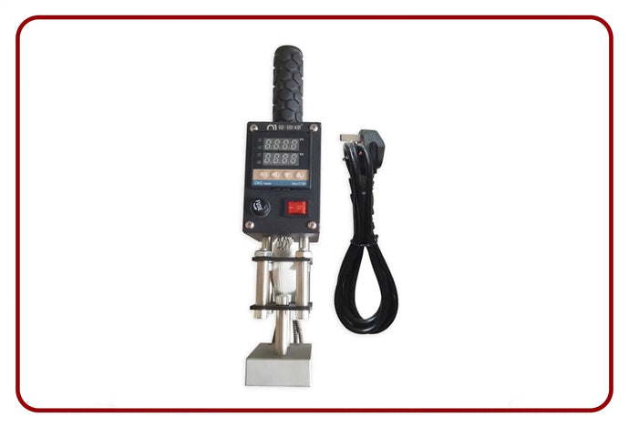 Black digital display machine with cord and handle, likely a pressure gauge or similar industrial tool.
