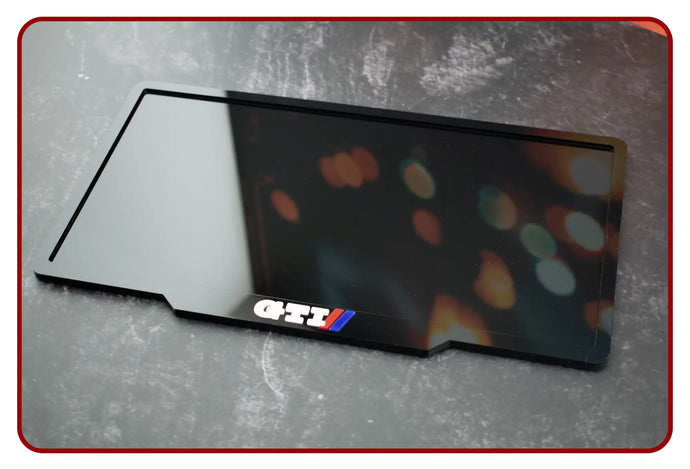 Black gti mouse pad with colorful light patterns and silver edges.
