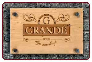 Wooden sign with 'GRANDE' branding on a stone wall background