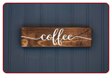 Wooden sign with 'coffee' written on it against a blue background