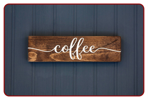 Wooden sign with 'coffee' written on it against a blue background