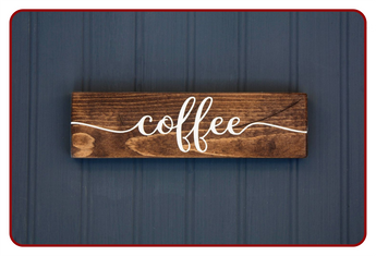 Wooden sign with 'coffee' written on it against a blue background
