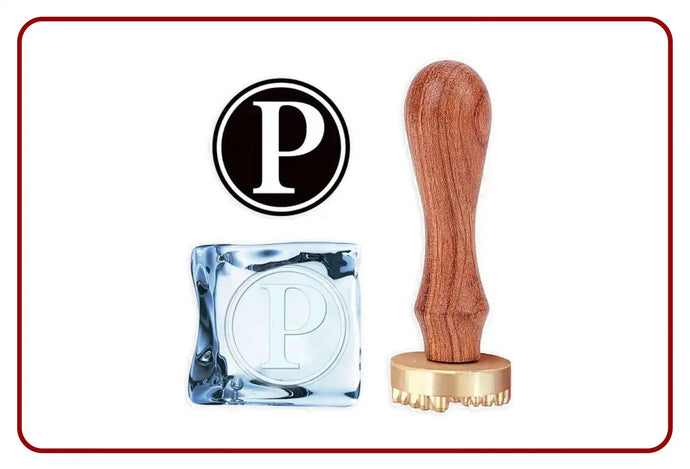 Wooden handle rubber stamp with gold base and engraved letter ’p’ design.