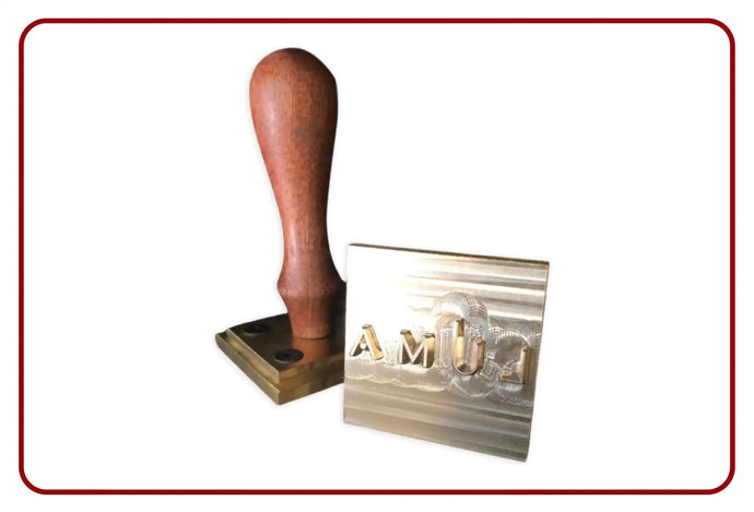 Wooden handle stamp with brass head and engraved initials ’amj’